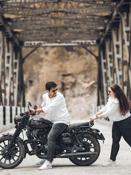 A playful and candid shot on the bridge, showing the fun side of the couple's relationship. These unposed moments are what make your pre-wedding album truly special.