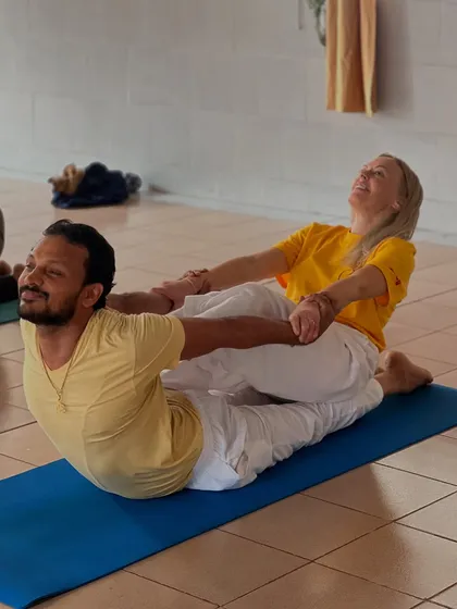 Partner work is an integral part of our advanced training. It helps students understand alignment and deepen their stretches, as seen here in this assisted Dhanurasana, or bow pose.