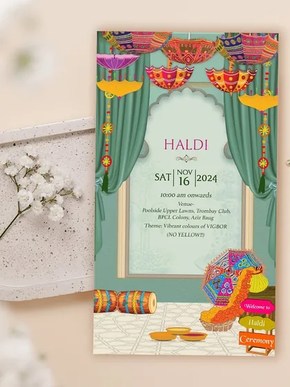 Who says Haldi has to be yellow? This vibrant Haldi invite breaks the mold with a "Vibrant colours of VIBGYOR" theme, featuring colorful Rajasthani umbrellas and decor.