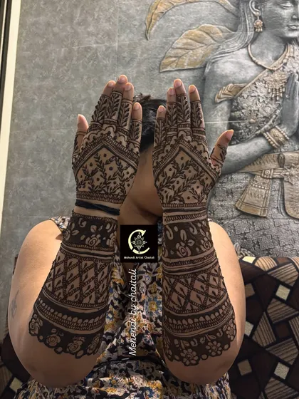 The back of the hands for a baby shower celebration. The design is full and intricate, matching the festive spirit of the event, with leafy patterns and geometric fills.