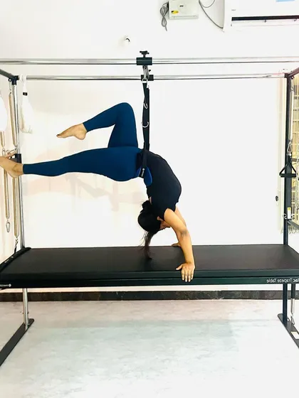 Using the push-through bar for a deep, controlled stretch, this pose improves flexibility while engaging the core for stability.