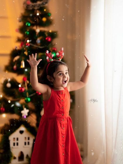 The excitement of a toddler enjoying the festive Christmas setup in my studio. I let kids play and explore to capture their natural joy.