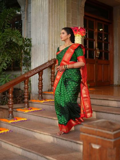 Shweta looking graceful in a traditional green and red Nauvari saree, ready for her event.
