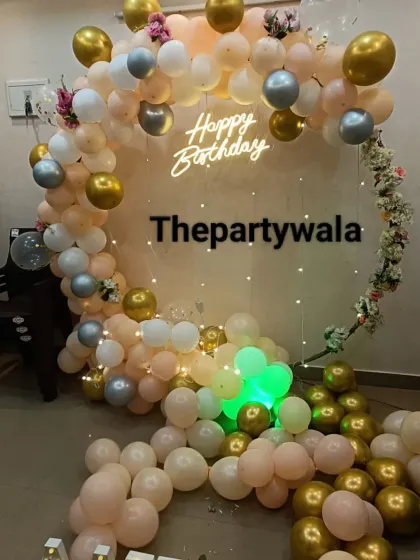 A cascade of pastel peach, white, and gold balloons. This style is very elegant and perfect for birthdays, anniversaries, or bridal showers.