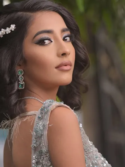 The side profile shows off the simple yet elegant hair accessory and the volume in the hairstyle.