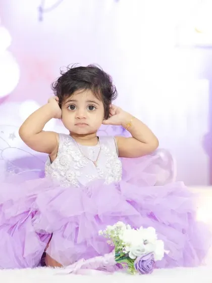"Did you get my good side?" This little one was a natural in front of the camera at her first birthday party. Kids' portraits are always full of surprises and fun.