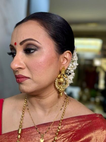 A profile view showcasing the elegant updo with fresh gajra and the beautifully blended smokey eye. My technique for mature eyes is to lift and define them.