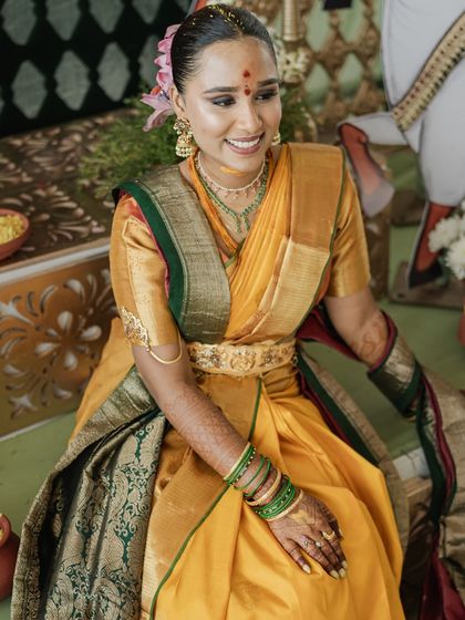 The bride, Manisha, looking radiant, draped in her mother's wedding saree for her Pradhanam ceremony.