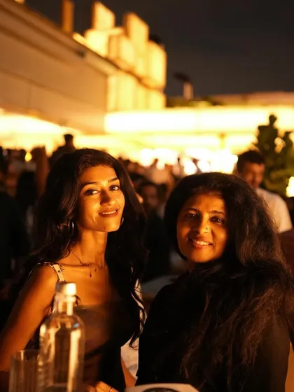 Two friends enjoying the beautiful rooftop setting at Pangeo.