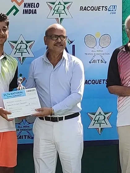 A male player is awarded his trophy at the National tournament.