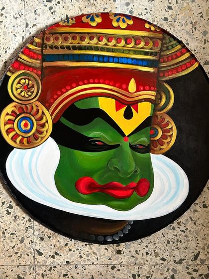 Another Kathakali face from the 'Navarasa' series, this one capturing a look of intense focus and emotion. The vibrant green face paint is characteristic of the heroic characters in Kathakali.