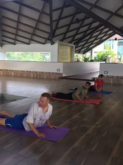 Guests practice Bhujangasana (Cobra Pose), a gentle backbend that helps strengthen the spine and relieve mild back pain and sciatica.