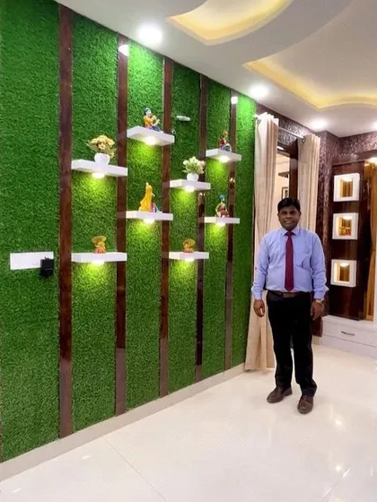 I stand by my work. This is an indoor feature wall I created using artificial grass, with custom shelving and lighting for a personalized touch.
