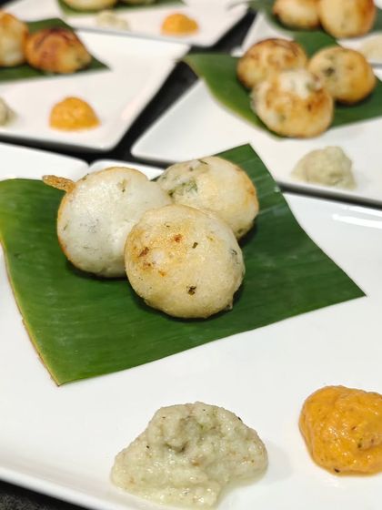 Appe with tomato and coconut chutney, served as a starter for a curated dining experience. These small, fluffy rice pancakes are a light and tasty way to begin a meal.