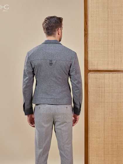 The back view of the grey monochrome shacket reveals subtle design details and a clean, tailored fit that is both modern and comfortable.