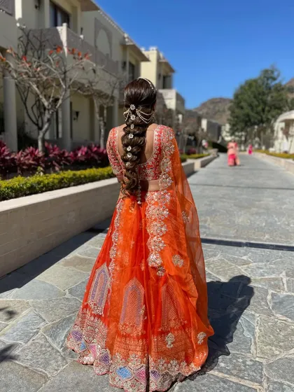 The full look of the bride with her intricate floral braid. This style is perfect for destination weddings, holding up beautifully while looking stunning in photos.