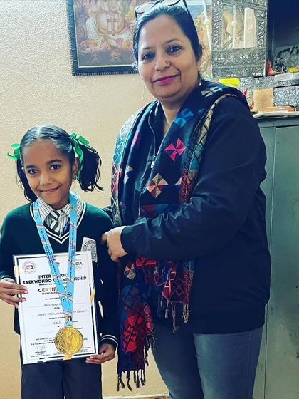 A gold medalist from the inter-school championship with her teacher. We celebrate every student's success.