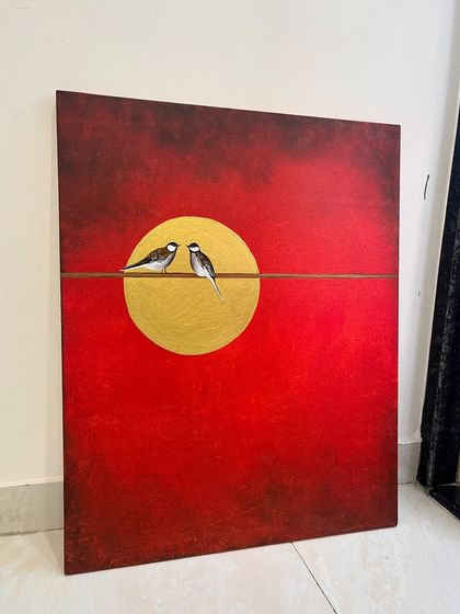 This 24" x 30" painting features two birds on a wire against a dramatic red sky and a gold leaf sun. It's a beautiful piece that symbolizes companionship and connection.