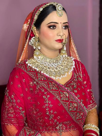 A classic bridal look with a bold red lip and perfectly defined eyes. She looks so poised and ready for her big moment.