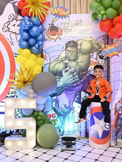 The birthday boy, Yuvaan, looking super cool next to the giant light-up '5' and Hulk backdrop. I love creating these special spots for the star of the day to shine.
