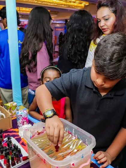 A marbling art station where kids can create beautiful swirled patterns on mugs. It's a magical process with a beautiful result.