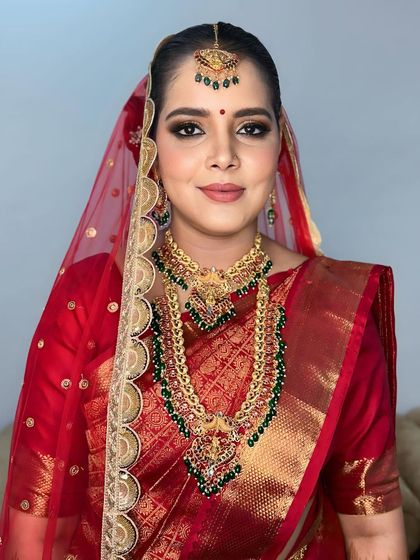 A direct portrait, capturing the intensity and beauty of the traditional South Indian bridal look.