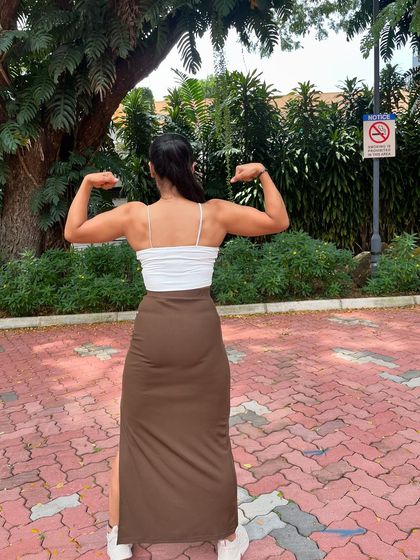 A back double bicep pose. Even without stage-level conditioning, the muscle I've built is visible.