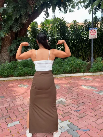 A back double bicep pose. Even without stage-level conditioning, the muscle I've built is visible.