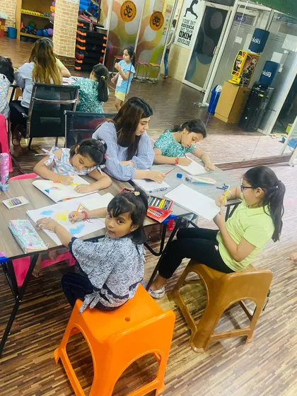 A snapshot of our group art workshop. Kids are sitting together, focused on their drawings and paintings. It's a great social activity that encourages creativity.