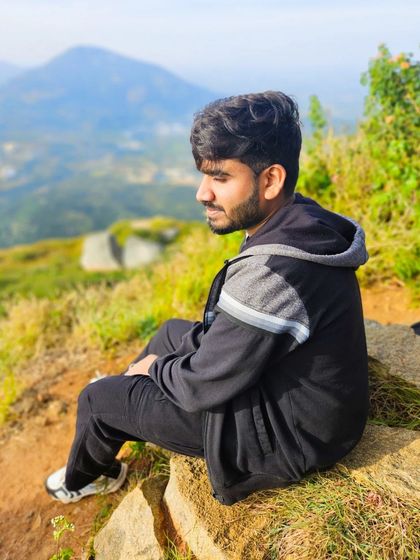 A candid shot of a trekker enjoying the view, capturing the relaxed and happy atmosphere of our trips.