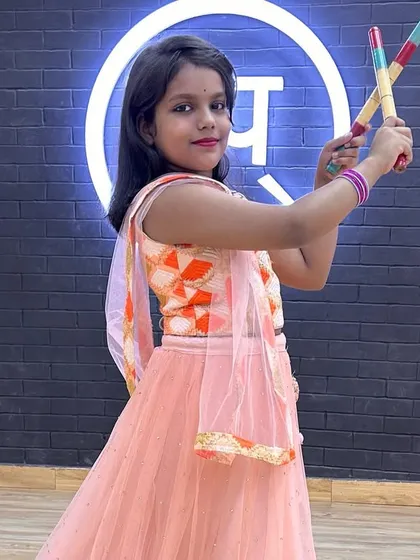 This young student is striking a pose with her dandiya sticks during our Navratri festivities.