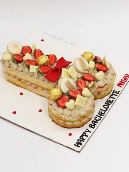 Another angle of the bachelorette tart cake, showing the fun shape and delicious toppings.