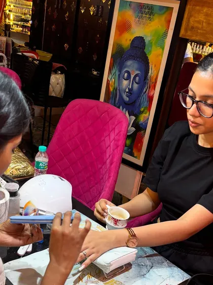 A close up of our artist working on a detailed cheetah print design. Every student gets one on one attention to perfect their technique, from nail prep and application to intricate art.