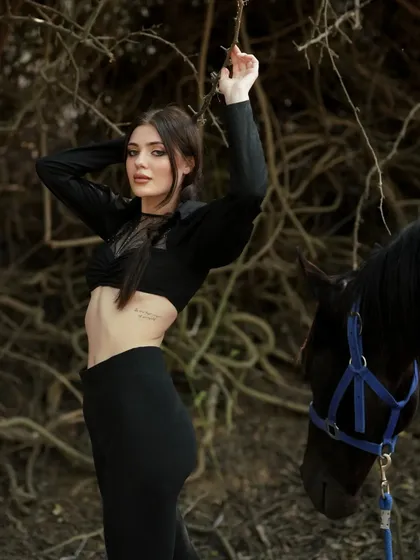 Another pose from the same series, with the model's pose creating a sense of movement and energy, complemented by the calm presence of the horse.