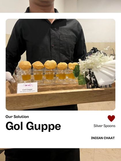 A server presenting my unique take on Gol Guppe. The tangy water is served in shot glasses with the puri on top, offering a fun and modern way to enjoy this street food classic.