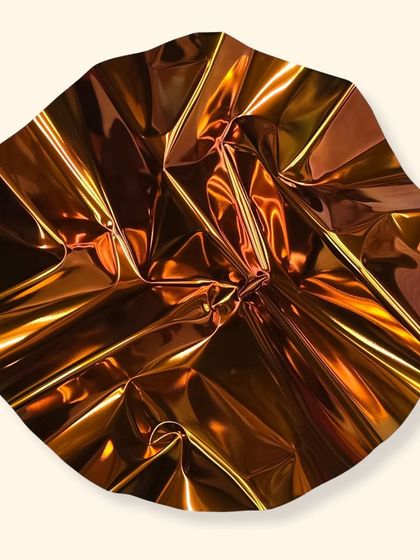 "Meteor 128" is a study in form and tension. The circular piece, finished in a fiery orange hue, captures the quiet drama of light bending across a sculpted surface.