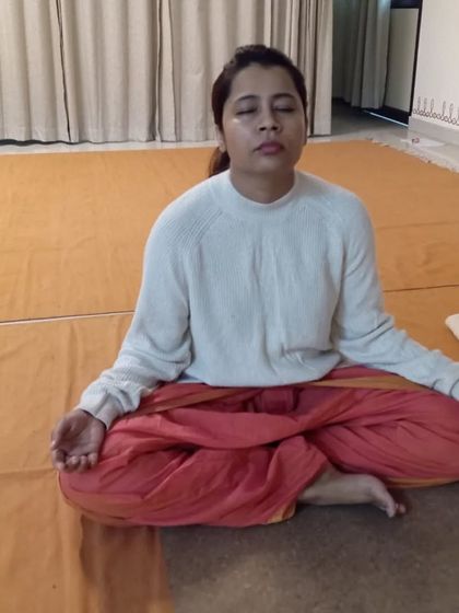 A participant sits in the starting meditative posture for Surya Kriya, preparing her system for the practice.