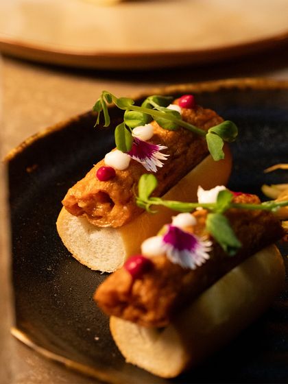 The details are what make a dish memorable. Here you can see the delicate placement of edible flowers and microgreens, adding a touch of artistry to the plate.
