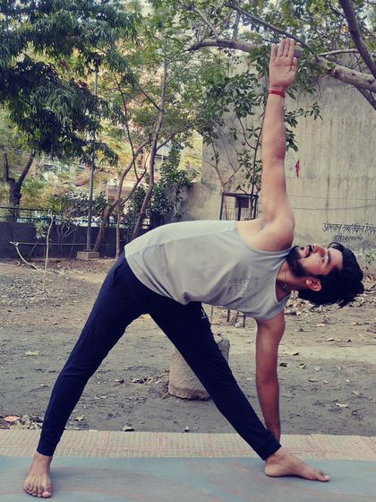 Utthita Trikonasana, or Extended Triangle Pose, is great for removing stiffness in the legs and hips. I teach this to stretch the neck and chest while improving stability.