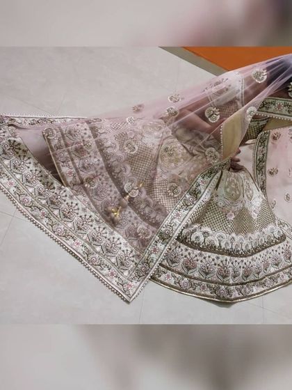 The complete bridal lehenga set, including the skirt, blouse, dupatta, and potli bag, carefully packed and ready for rental.