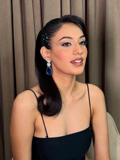 A smiling shot that shows off the beautiful shimmer on the eyelids. The light catches the glitter and rhinestones, making the whole look come alive.