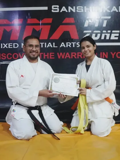 We celebrate every step of our students' progress. This moment captures the pride and accomplishment of earning a new rank in karate through hard work and consistent practice.