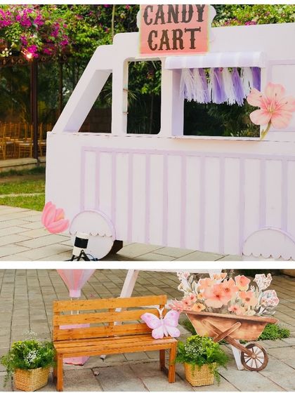 A whimsical candy cart and a park bench photo spot from Hitanshi's enchanted garden party.