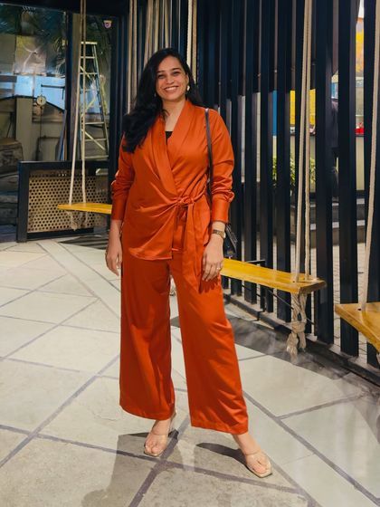 "Diva Energy Only." This photo shows me in a stylish rust-colored co-ord set at a cafe. It's a confident, fashionable look that represents my personal style outside of "mom mode."