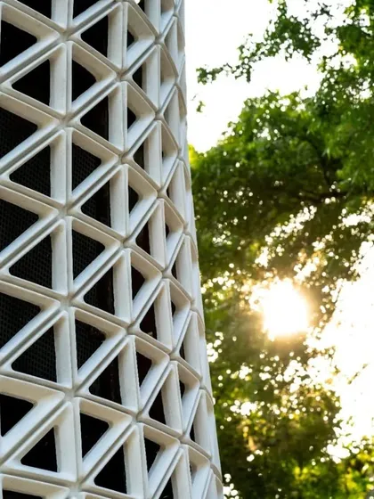 A close-up view of the VERTO facade against the sun. The design uses principles of aerodynamics to maximize surface area and wind speed, resulting in a robust and efficient air purification system.