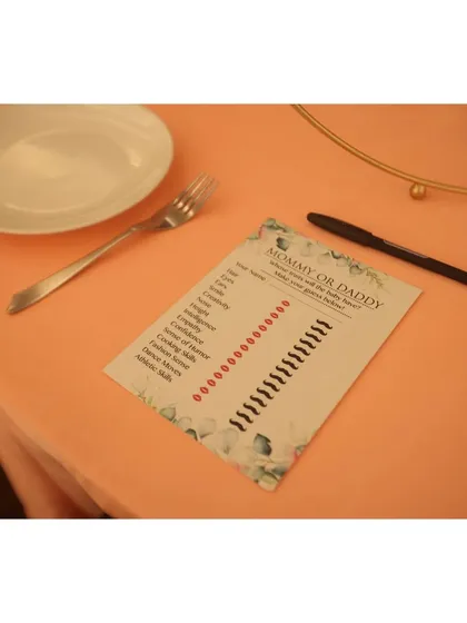 An interactive "Mommy or Daddy?" quiz placed on each table, a fun and simple way to get guests laughing and engaging with each other.