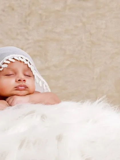 Another take on the popular lace veil pose, capturing the baby in a moment of deep, peaceful sleep.