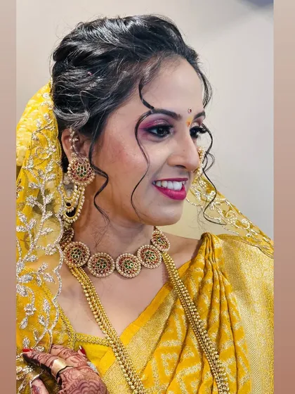 Another angle of the makeup and hairstyle, showing the soft curls framing her face.