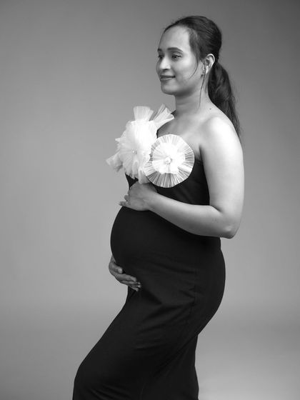 A beautiful black and white portrait of a client in our Veneccia gown. The simple, clean background keeps the focus on her and the dress.