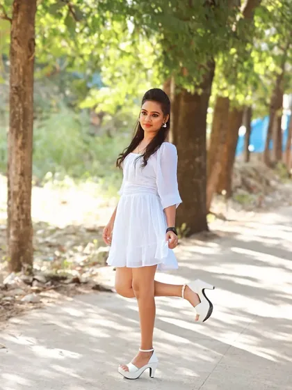 A full-length shot from the western wear photoshoot. The makeup is clean and natural, perfect for a sunny day outdoors.